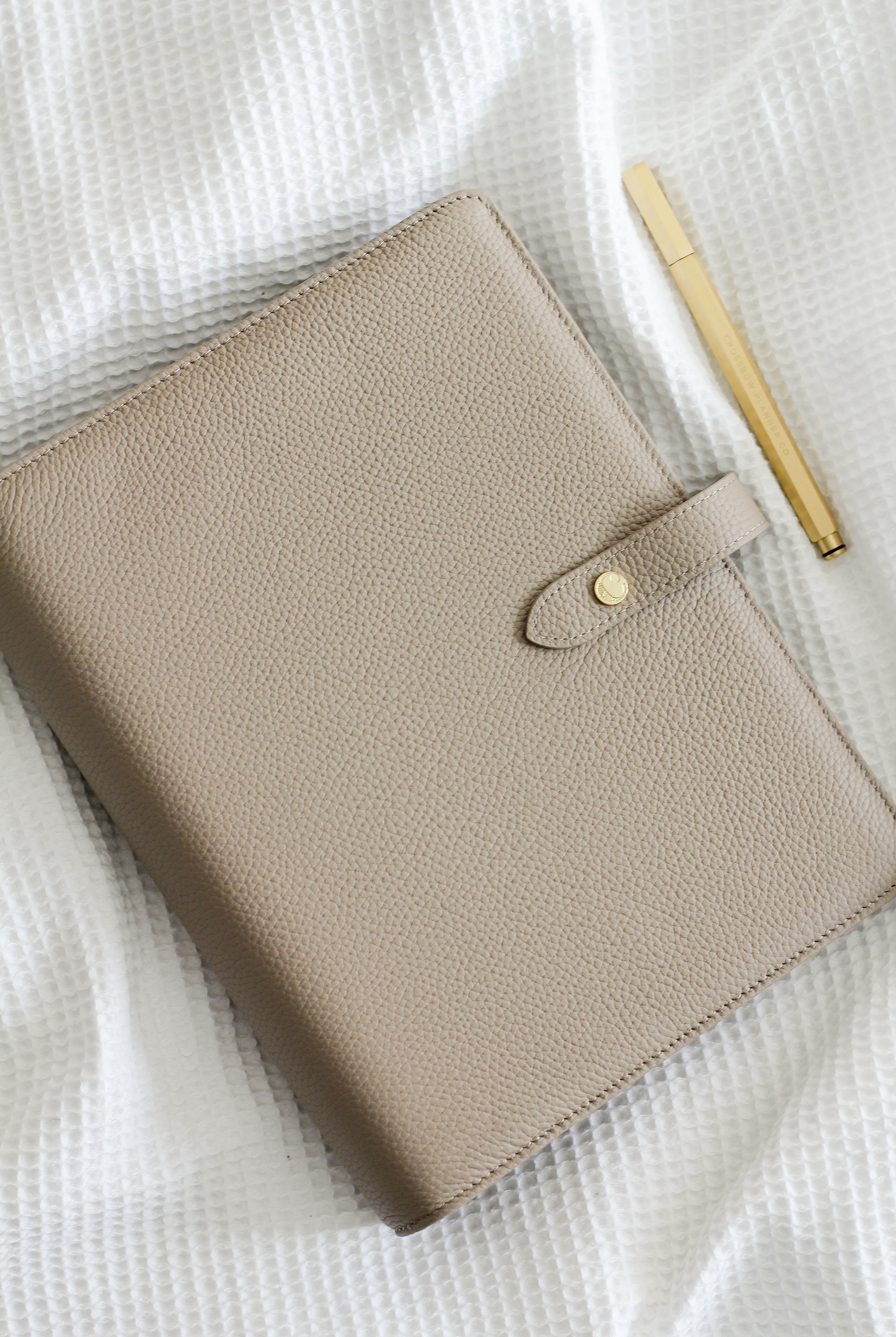 leather planner cover in taupe with gold brass pen