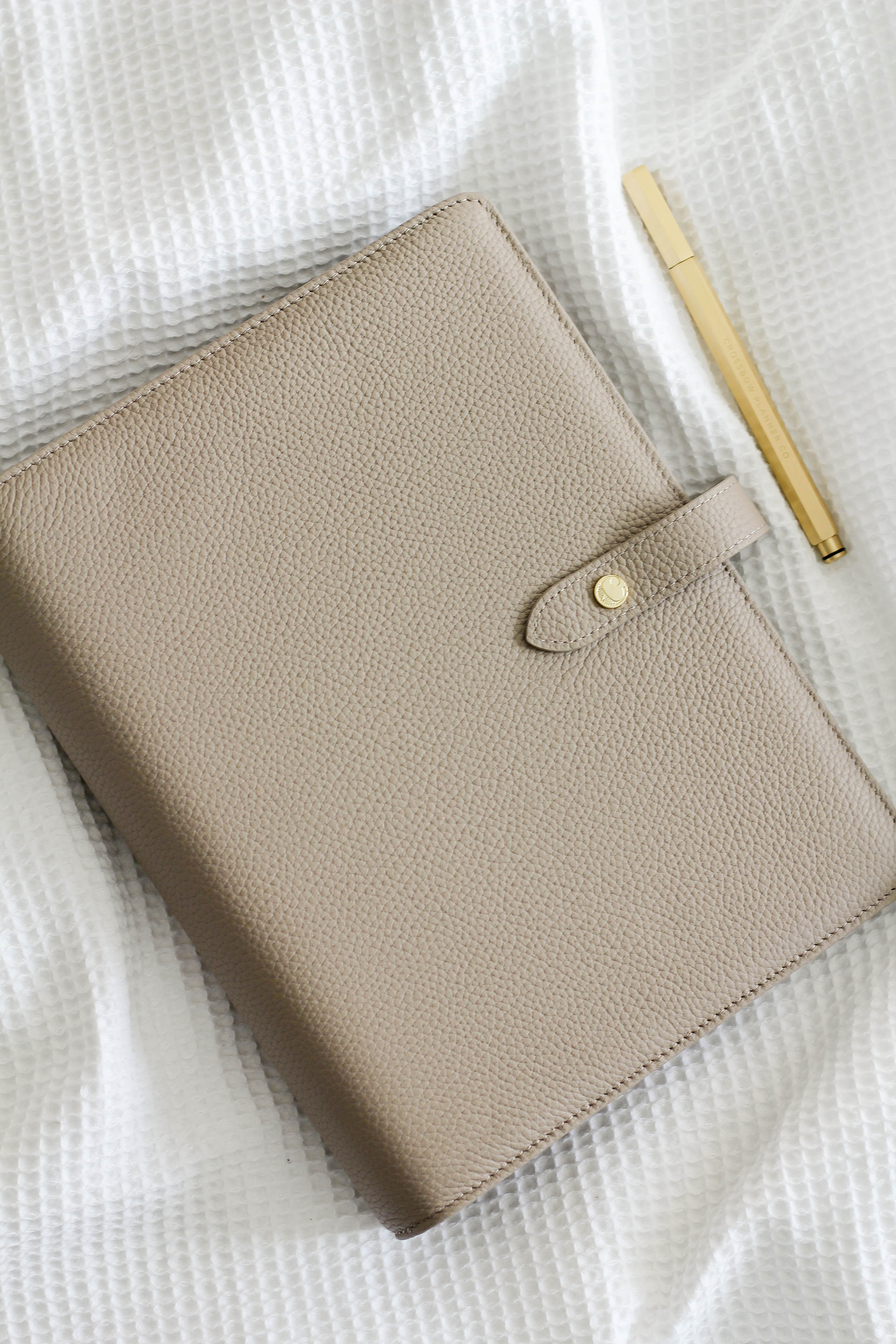 leather planner cover in taupe with gold brass pen